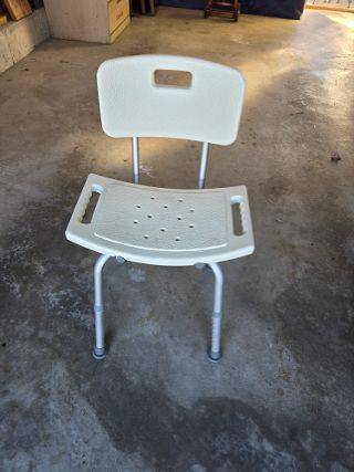 Shower bench with adjustable back rest and padded arms